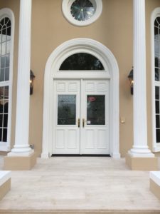 A long shot of the white door and pillars